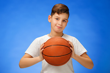 Image showing Adorable 11 year old boy child with basketball ball