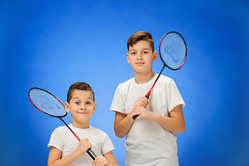 Image showing The two boys with badminton rackets outdoors