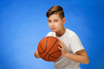 Image showing Adorable 11 year old boy child with basketball ball