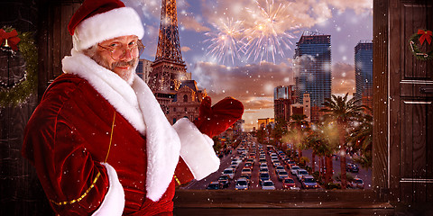 Image showing The man in costume of santa claus over night city background