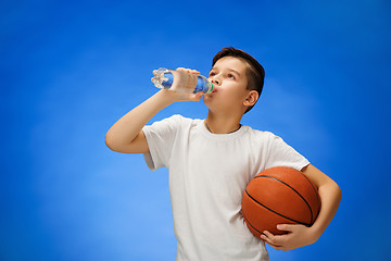Image showing Adorable 11 year old boy child with basketball ball