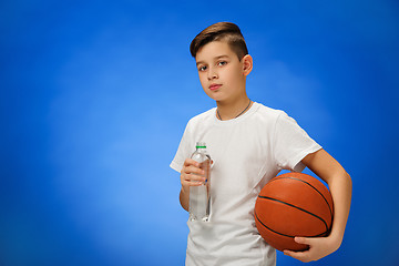 Image showing Adorable 11 year old boy child with basketball ball