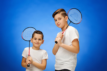 Image showing The two boys with badminton rackets outdoors