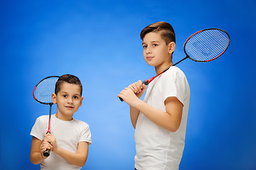 Image showing The two boys with  badminton rackets outdoors