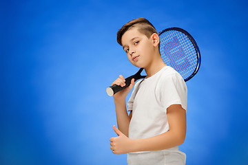 Image showing Young tennis player on blue background.