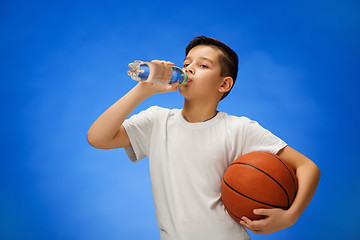 Image showing Adorable 11 year old boy child with basketball ball