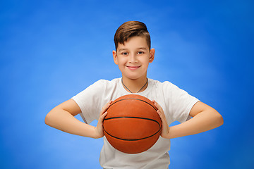 Image showing Adorable 11 year old boy child with basketball ball