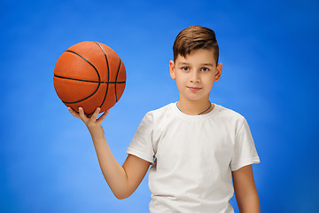 Image showing Adorable 11 year old boy child with basketball ball