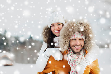 Image showing happy couple having fun over winter background