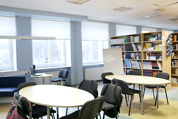 Image showing tables with chairs and backpacks at library room