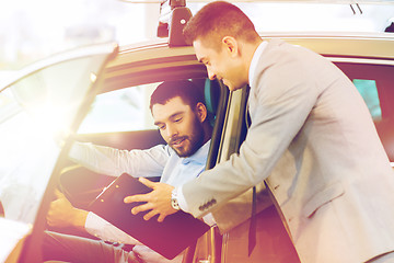 Image showing happy man with car dealer in auto show or salon