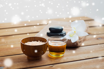 Image showing pink salt with honey, bath towel and hot stones