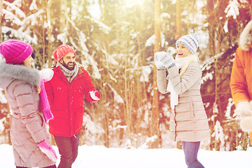 Image showing happy friends playing snowball in winter forest