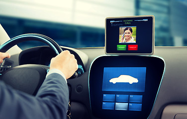 Image showing close up of man driving car and receiving call