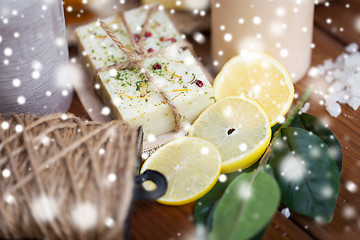 Image showing natural soap and candles on wood