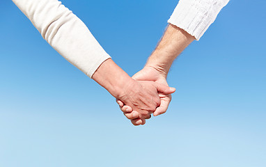 Image showing close up of senior couple holding hands