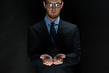 Image showing close up of businessman holding something in hands