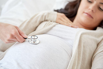 Image showing doctor with stethoscope and pregnant woman