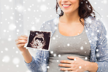 Image showing close up of pregnant woman with ultrasound image