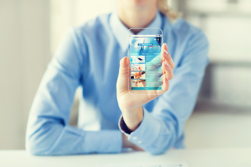 Image showing close up of woman with world news on smartphone