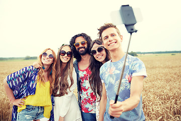 Image showing hippie friends with smartphone on selfie stick