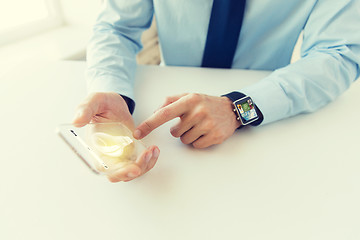 Image showing close up of hands with smart phone and watch