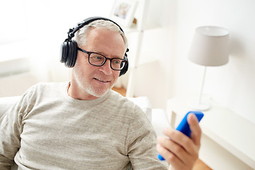 Image showing happy senior man with smartphone and headphones