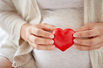 Image showing close up of pregnant woman with red heart