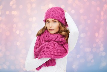 Image showing woman in hat and scarf over pink lights background