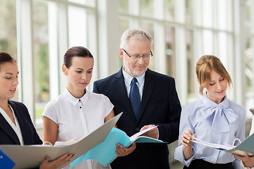 Image showing business team with tablet pc and folders at office