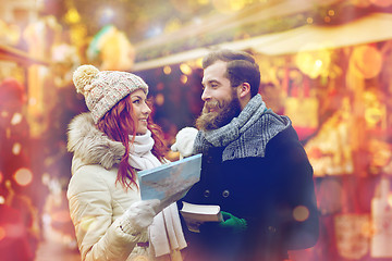 Image showing happy couple with map and city guide in old town