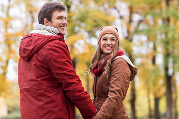 Image showing happy young couple walking in autumn park