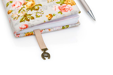 Image showing Handmade notebook fragment with horseshoe bookmark