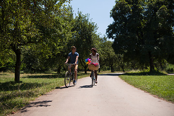 Image showing Young multiethnic couple having a bike ride in nature