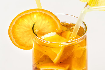 Image showing Close up orange cooler cocktail with drinking straw on white background