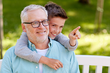 Image showing grandfather and boy pointing finger at summer park