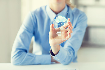 Image showing close up of woman with weather app on smartphone