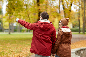 Image showing happy young couple walking in autumn park