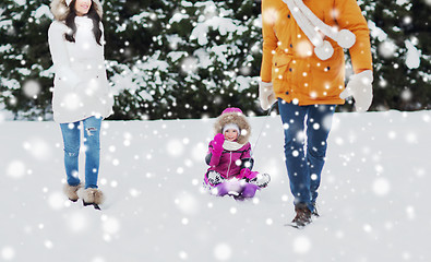 Image showing happy family with sled walking in winter forest