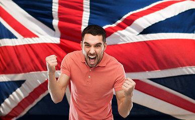 Image showing angry man showing fists over brittish flag