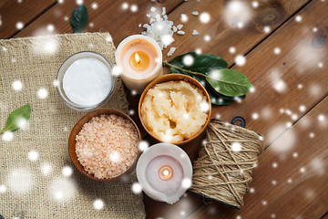 Image showing natural body scrub and candles on wood