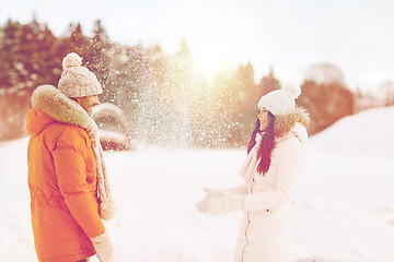 Image showing happy couple playing with snow in winter