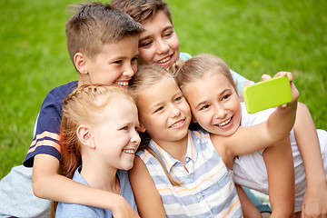 Image showing happy kids or friends taking selfie in summer park