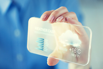 Image showing close up of woman with weather cast on smartphone