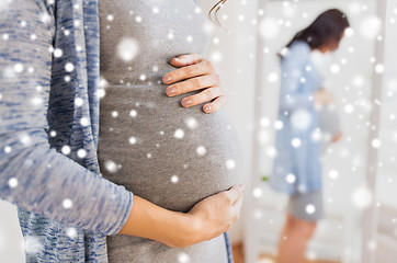 Image showing close up of pregnant woman looking to mirror