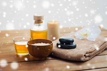 Image showing himalayan pink salt, massage oil and bath towel