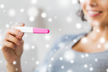 Image showing close up of happy woman with home pregnancy test