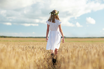 Image showing happy young woman in flower wreath on cereal field