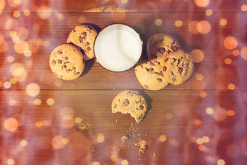 Image showing christmas oat cookies and milk on wooden table