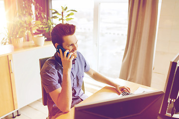 Image showing happy creative male worker calling on smarphone